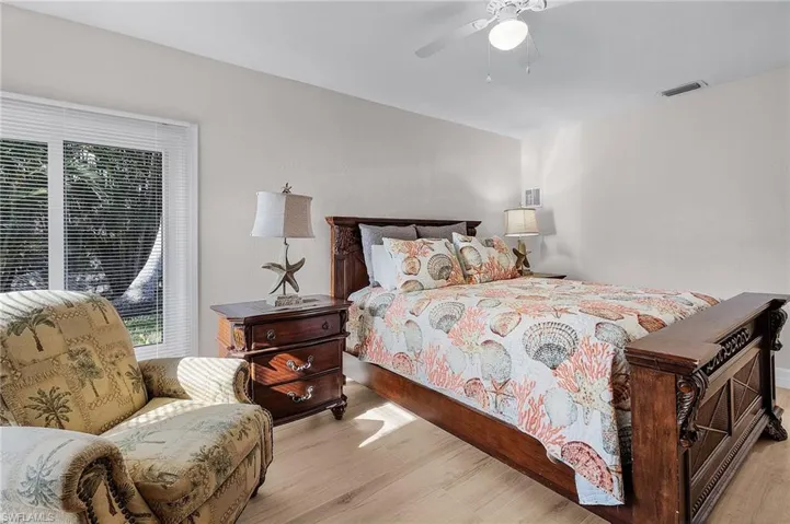 Bedroom featuring wood finished floors and a ceiling fan