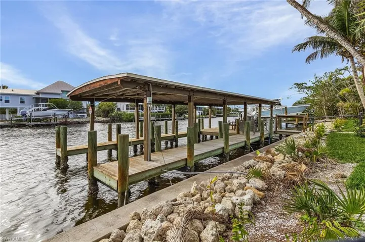 Dock area with a water view and boat lift