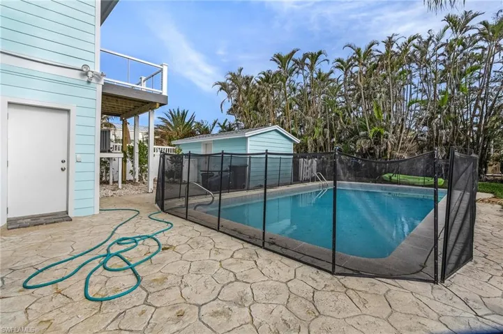 View of swimming pool with a patio and a balcony