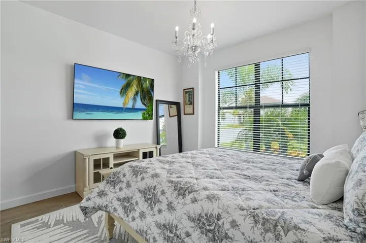 Bedroom featuring wood finished floors and a chandelier