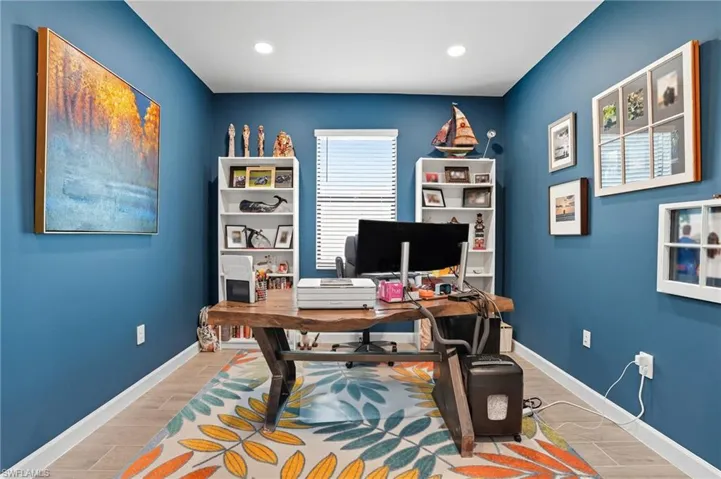 Office with wood finish floors and recessed lighting