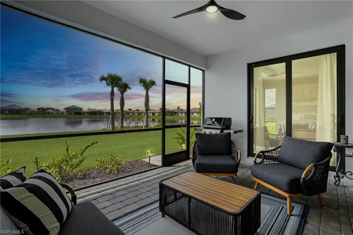 Sunroom / solarium with a water view and a residential view