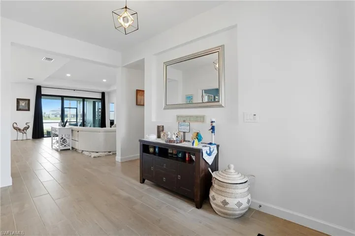 Hall featuring light wood finished floors and recessed lighting