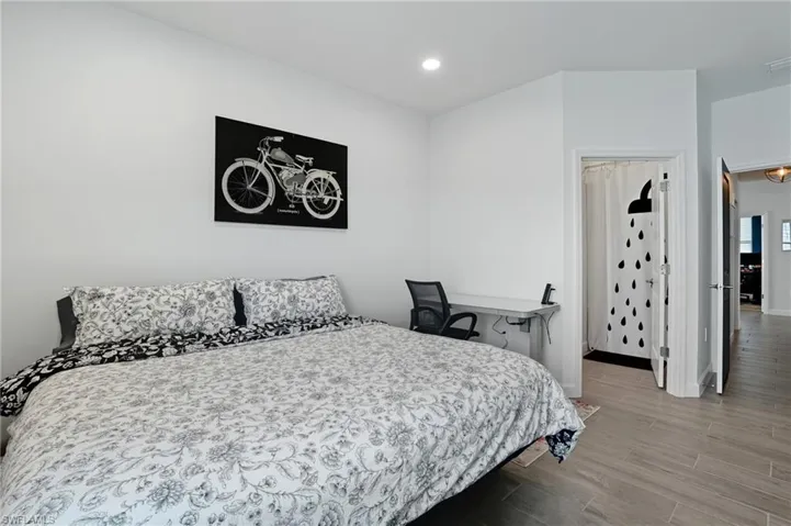 Bedroom with light wood-style floors and recessed lighting