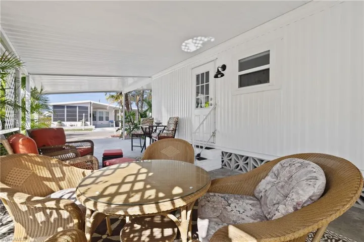 Sunroom featuring outdoor dining area and a patio area