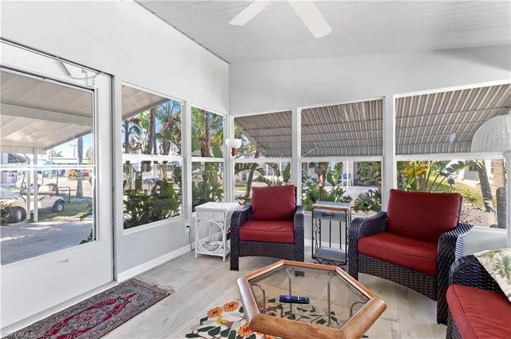 Sunroom with healthy amount of natural light, vaulted ceiling, and a ceiling fan