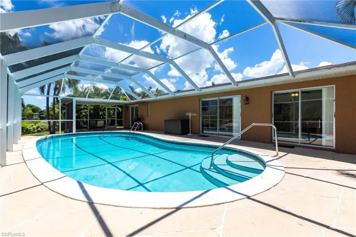 Outdoor pool with a patio, a lanai, and a sunroom