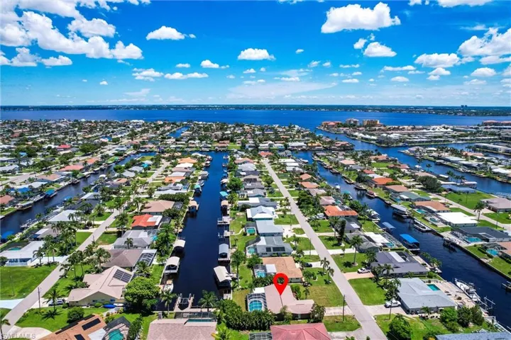 Aerial view of property and surrounding area with nearby suburban area