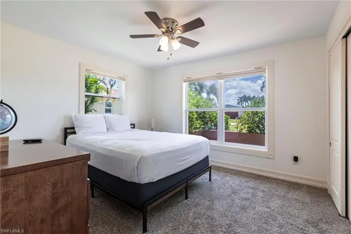 Bedroom featuring a ceiling fan, carpet floors, and a closet