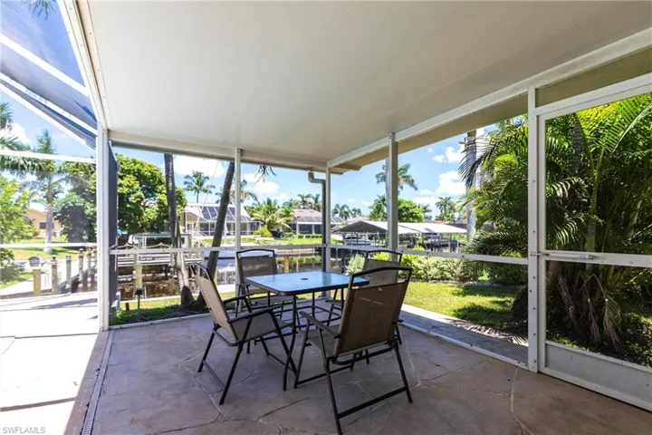 Sunroom / solarium featuring a residential view and outdoor dining area