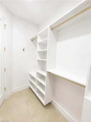 Custom-designed closet system featuring extensive shelving and hanging rods