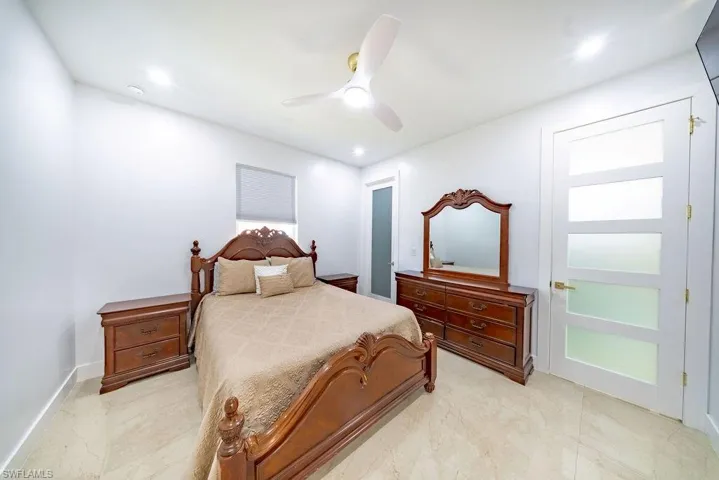 Neutral-toned tile flooring complements bright white walls
