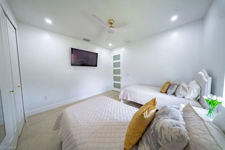 White interior room featuring recessed lighting and a ceiling fan with gold-finish accents