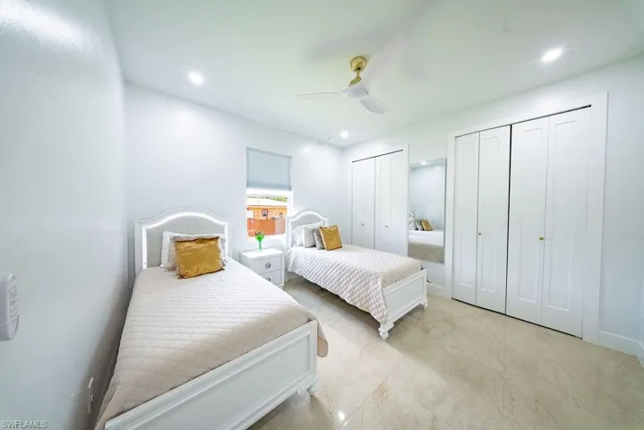 Bright room featuring light-toned flooring, recessed lighting, and a ceiling fan