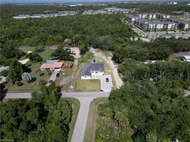 Single-story residence featuring a gray shingle roof and a concrete paver driveway