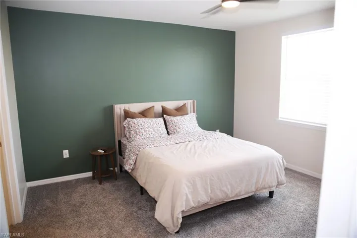 Bedroom featuring ceiling fan and carpet flooring