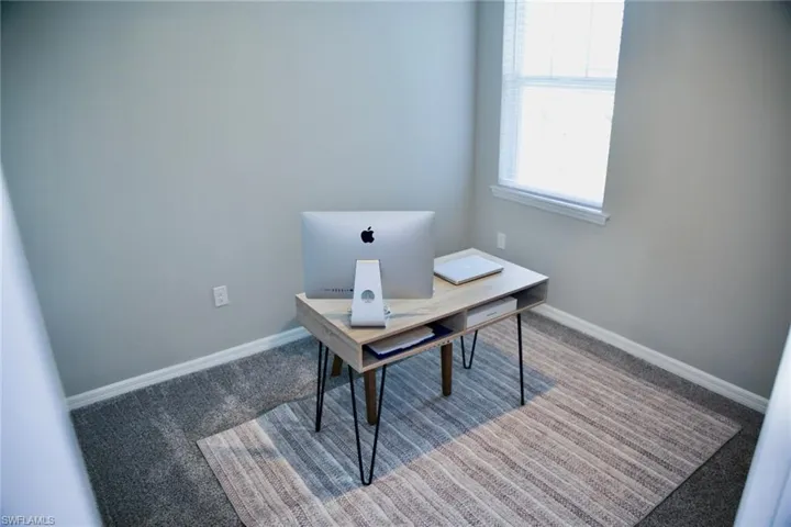 Office area featuring carpet flooring and baseboards