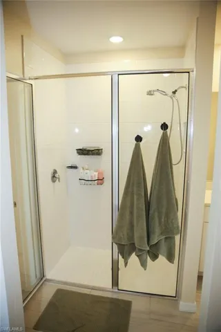 Bathroom featuring a shower stall, recessed lighting, vanity, and light wood-style floors