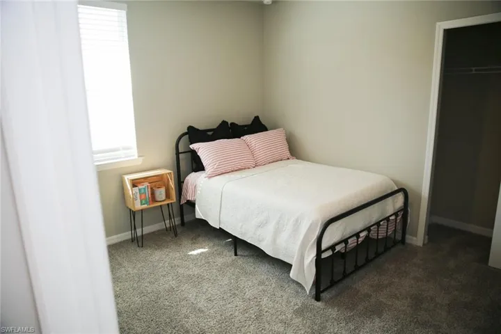 Carpeted bedroom featuring baseboards