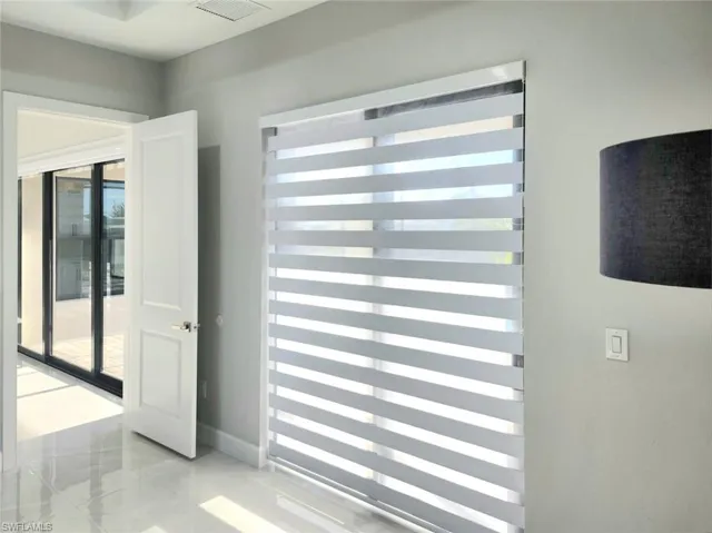 Doorway to outside featuring marble finish floor, baseboards, and visible vents