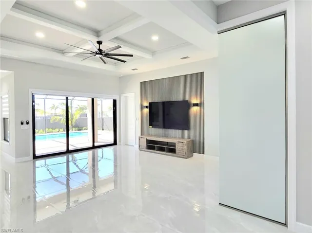 Unfurnished living room with coffered ceiling, marble finish floor, beam ceiling, and recessed lighting