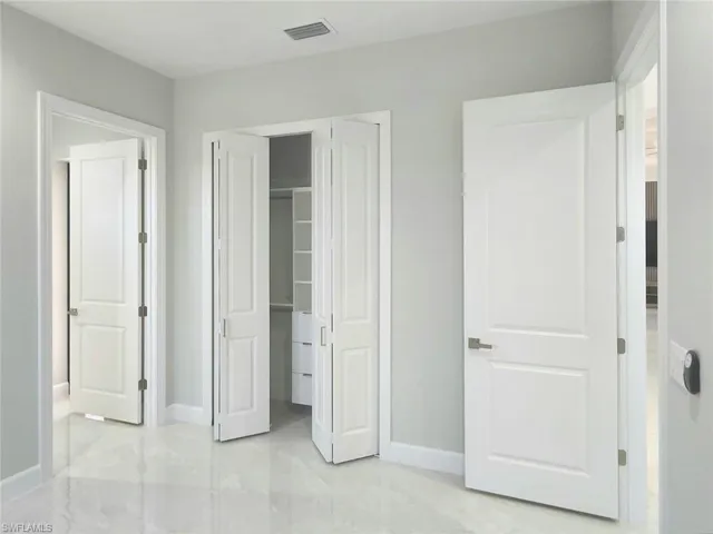 Unfurnished bedroom featuring visible vents, baseboards, and a closet
