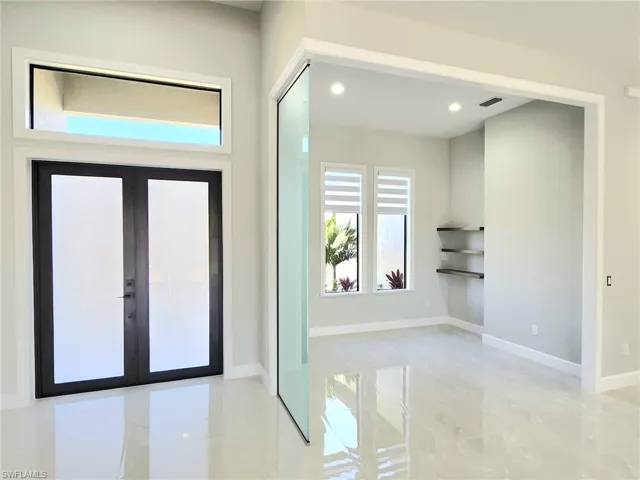 Entryway featuring recessed lighting, visible vents, baseboards, and french doors