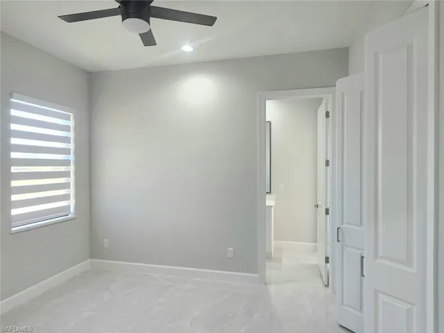 Empty room with baseboards, a ceiling fan, marble finish floor, and recessed lighting