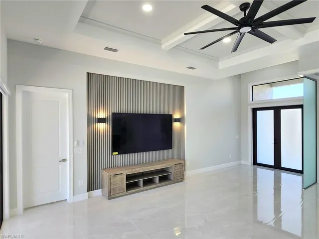 Unfurnished living room with baseboards, a ceiling fan, visible vents, and recessed lighting