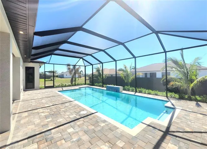 Pool featuring a patio and glass enclosure