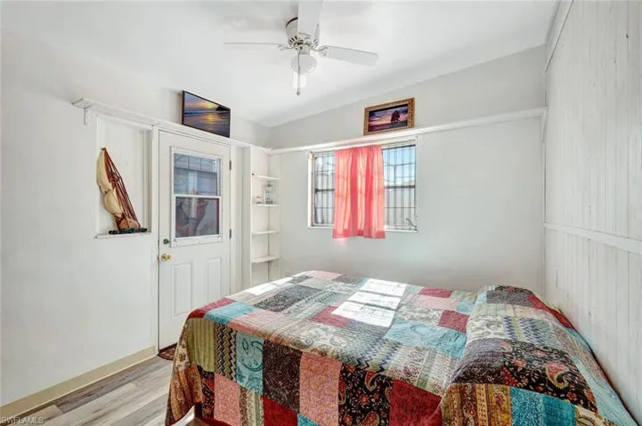 Unit One Bedroom with door leading out to back patio.