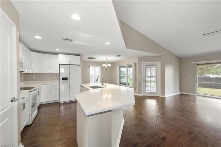 Single story home with driveway, stucco siding, and an attached garage