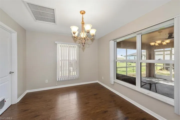 Kitchen featuring white cabinets, recessed lighting, white appliances, dark wood finished floors, and open floor plan