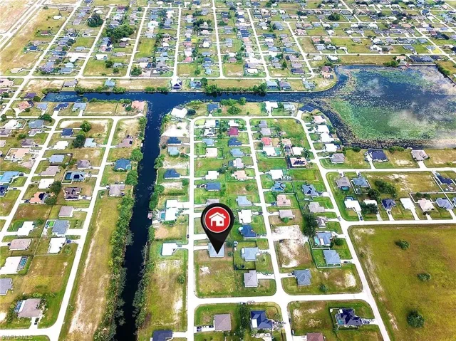 Aerial overview of property's location with nearby suburban area and a nearby body of water