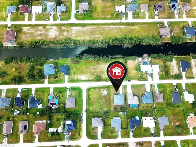 Aerial overview of property's location featuring nearby suburban area and a large body of water