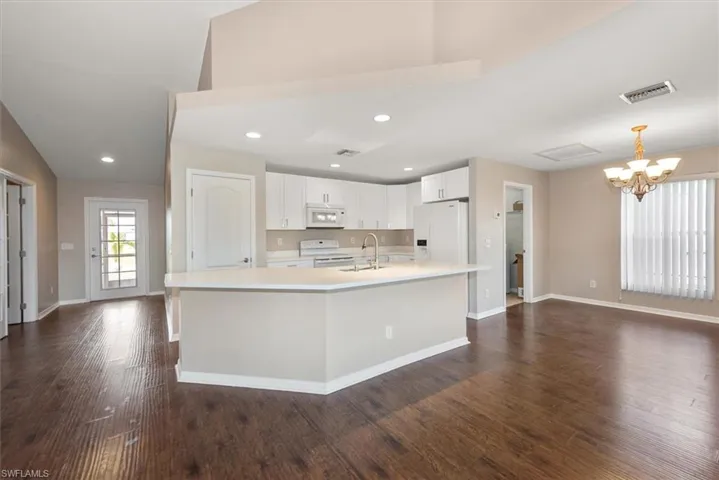 Empty room with dark wood-type flooring, french doors, and ceiling fan