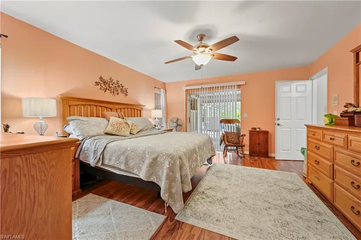 Bedroom with ceiling fan, hardwood / wood-style flooring, and access to exterior