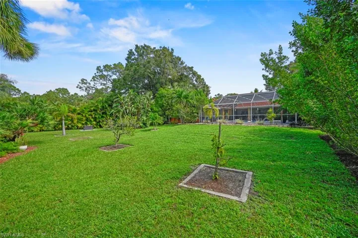 View of yard with glass enclosure