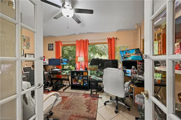 Tiled home office featuring ceiling fan