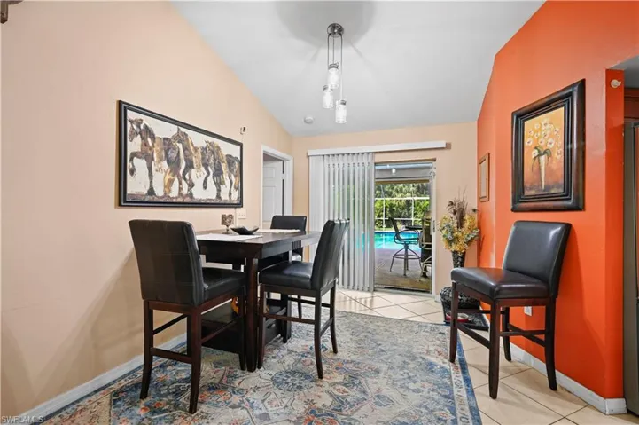 Tiled dining space with vaulted ceiling