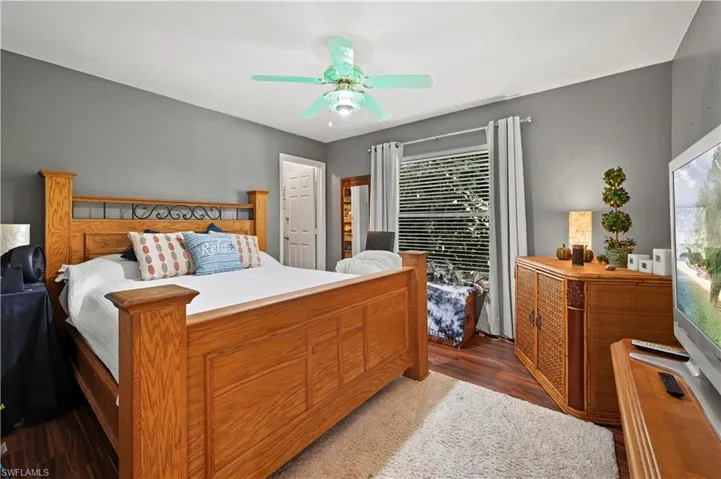 Bedroom with ceiling fan and dark hardwood / wood-style floors