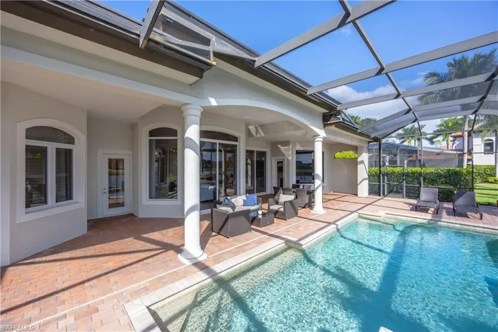 Outdoor pool featuring a sunroom, a lanai, a patio area, and outdoor lounge area
