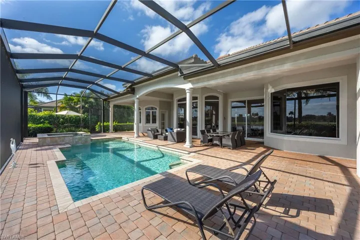 View of swimming pool with a sunroom, a patio, a lanai, and a pool with connected hot tub