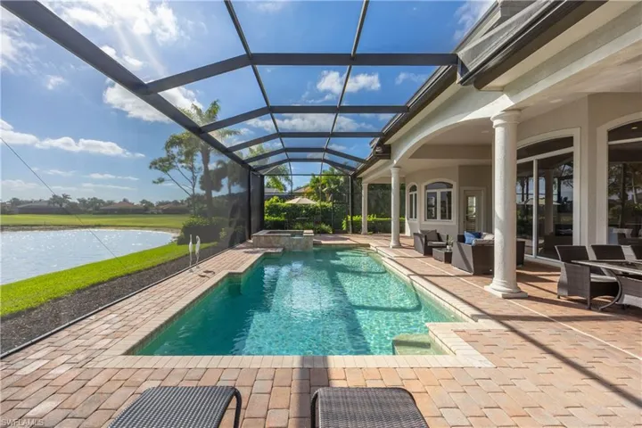 View of pool featuring a sunroom, a patio, a pool with connected hot tub, a lanai, and an outdoor hangout area