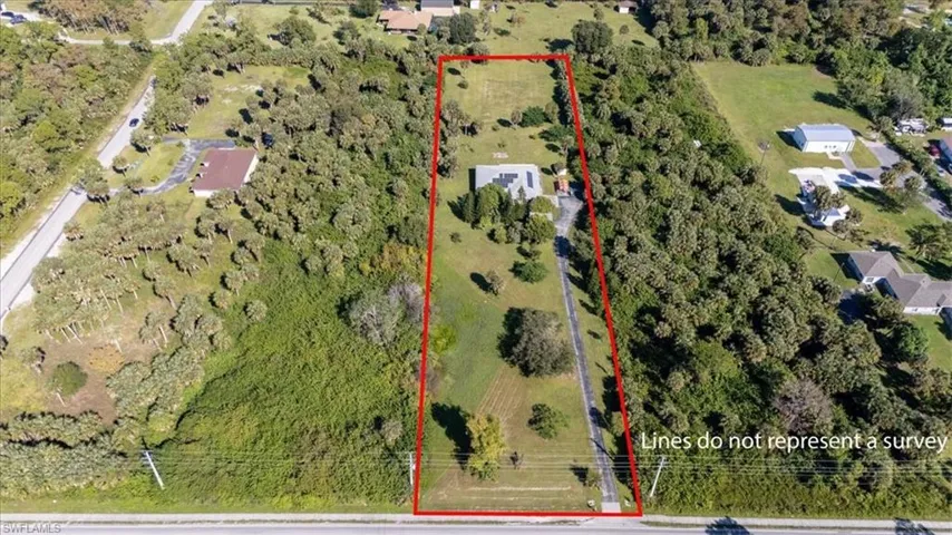 Aerial view of property and surrounding area with property parcel outlined