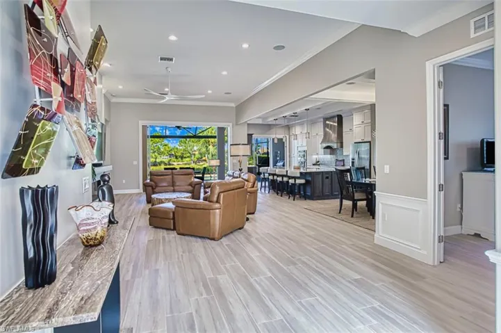 Kitchen with beam ceiling, hanging light fixtures, tasteful backsplash, appliances with stainless steel finishes, and dark brown cabinets