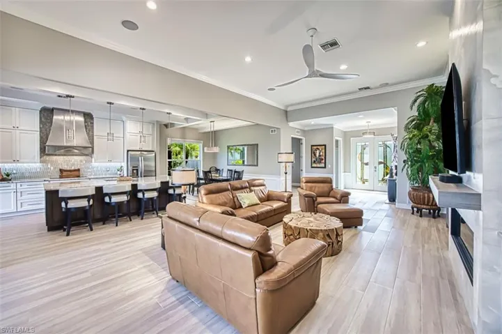 Bedroom with access to exterior, crown molding, a ceiling fan, light wood-type flooring, and recessed lighting