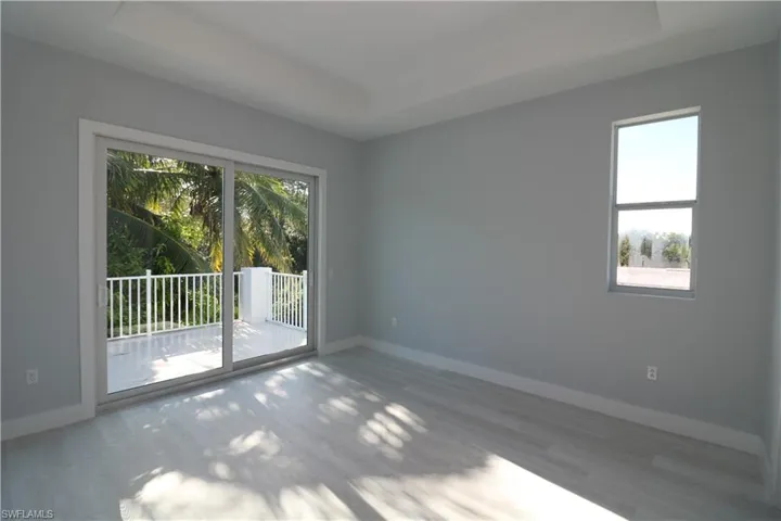Empty room featuring hardwood / wood-style flooring and a raised ceiling