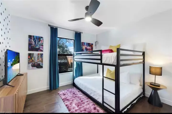 Bedroom featuring dark wood finished floors and ceiling fan