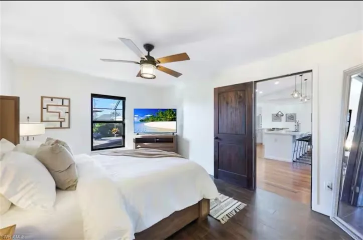 Bedroom featuring dark wood finished floors and a ceiling fan